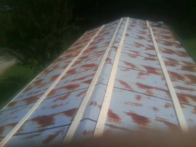 Rusted metal roof panels with new wood purlins before replacement — Storm Damage Roof Repair in Newville by Roofing Brothers