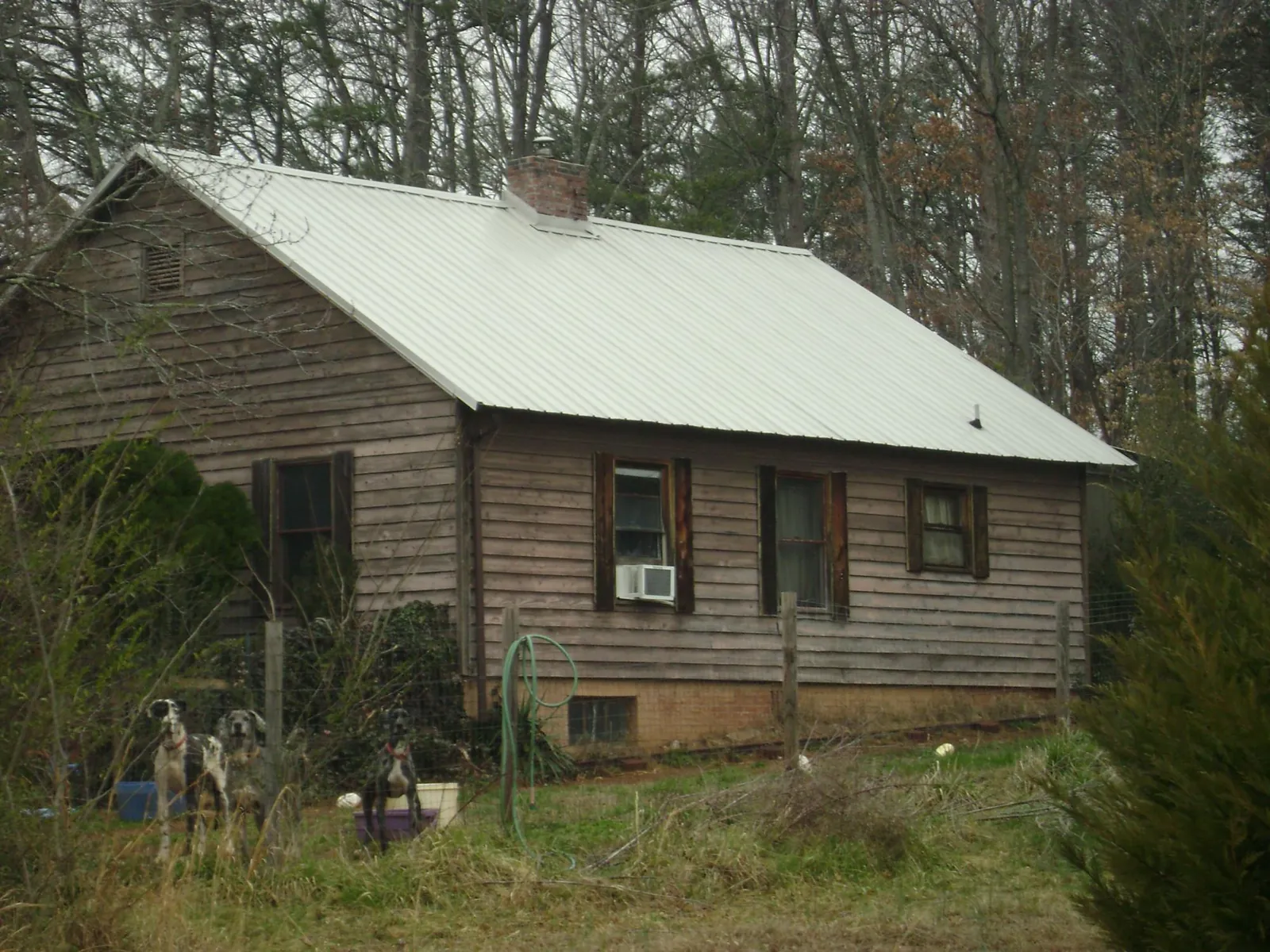 White metal roof on an old wood sided farmhouse, from a Metal Roof Installation job in Newville